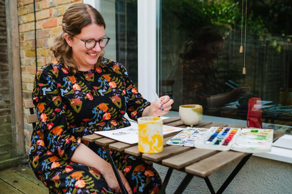 Sam painting in her garden.