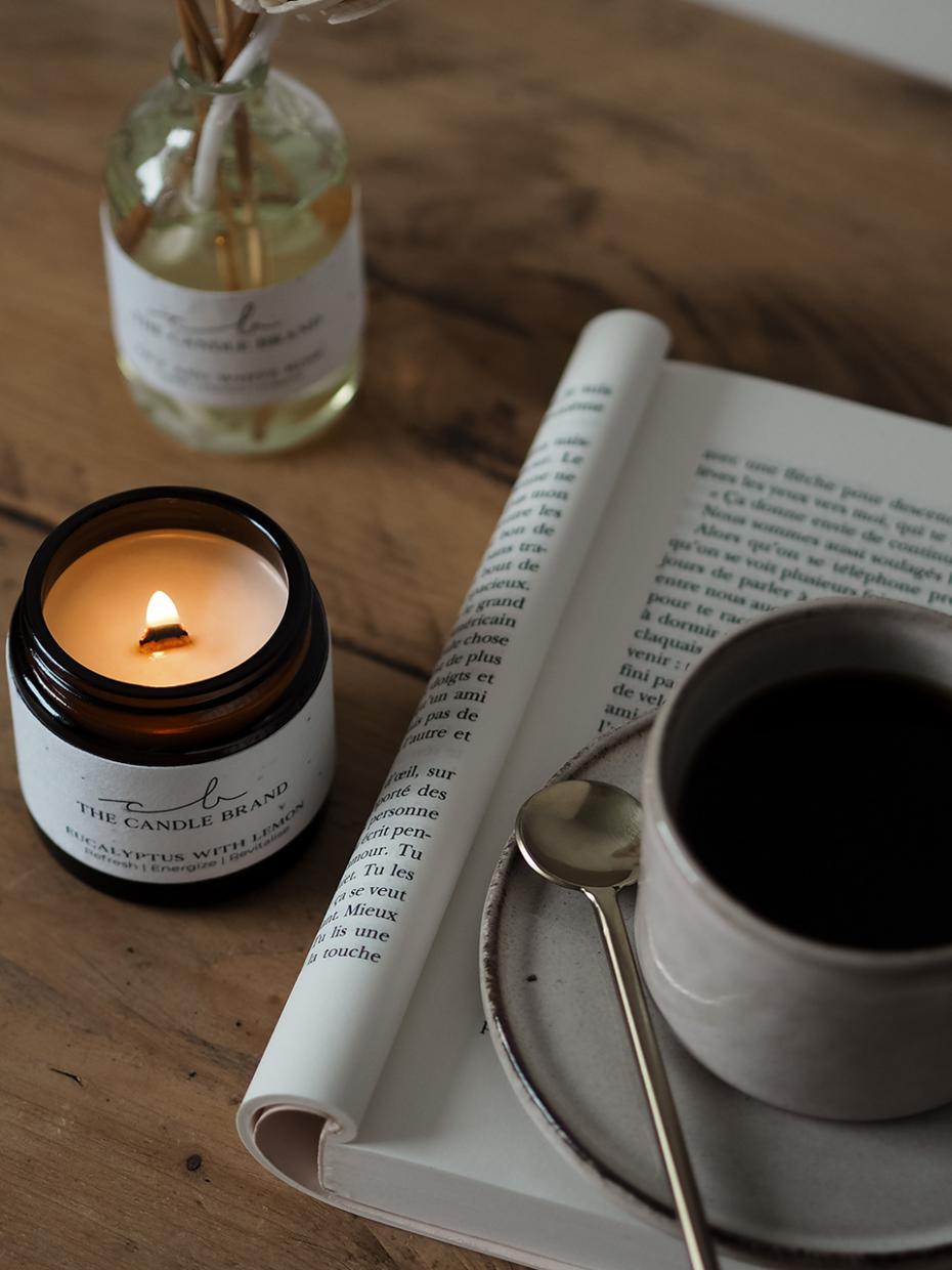 Coffee and book with candle alight