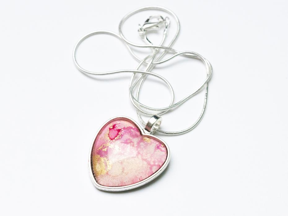 Pale pink and gold original alcohol ink art sealed with a glass cabochon