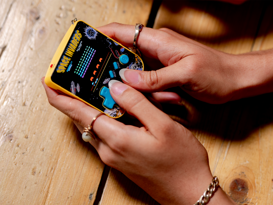 A miniature arcade experience with authentic button controls and classic gameplay.