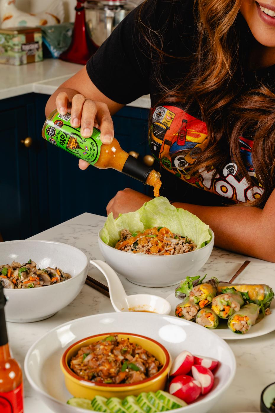 Pouring on the Ginger Chilli Sauce