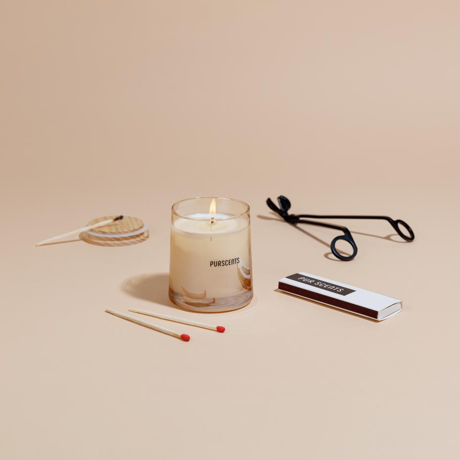 Lit Purscent candle with trimmer and candle match
