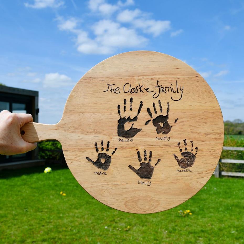 Engraved wooden pizza board with family handprints