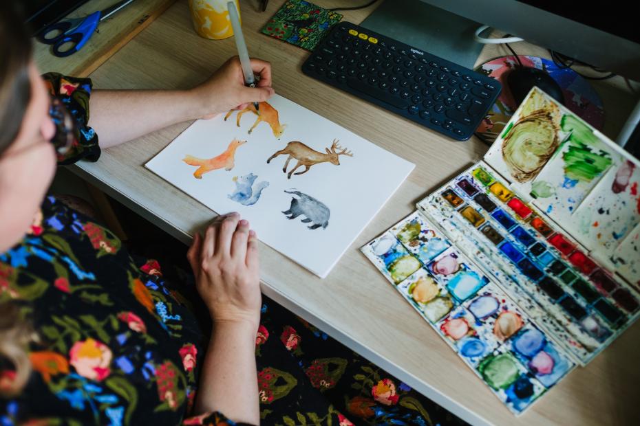 Samantha painting with watercolours. Prepping the designs.